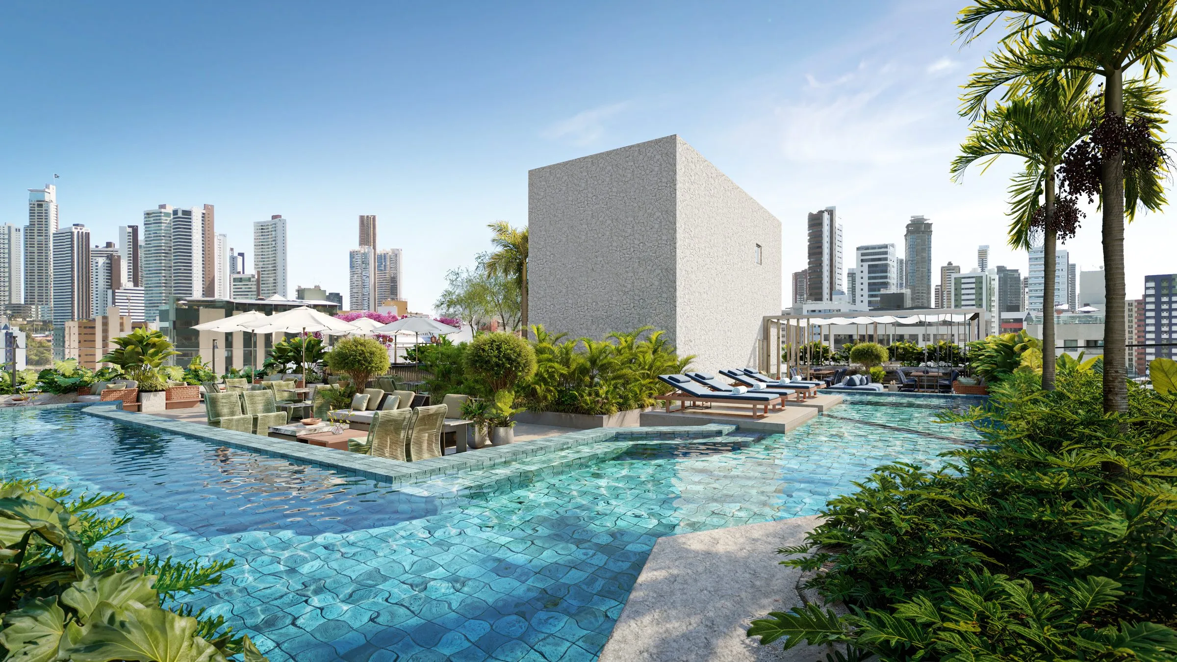 Piscina do rooftop do Lumini ao entardecer, com lounges e a cidade ao fundo